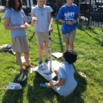 Adaire students working together to build a paper tower for STEM day.