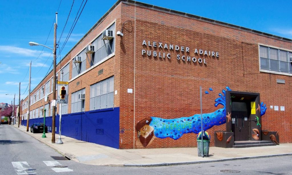 Mural painted outside the Adaire School main entrance depicting a treasure chest and several underwater objects.