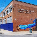 Mural painted outside the Adaire School main entrance depicting a treasure chest and several underwater objects.