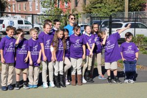 A group of Adaire Playworks Junior Coaches pose for a photo during school yard opening ceremony.